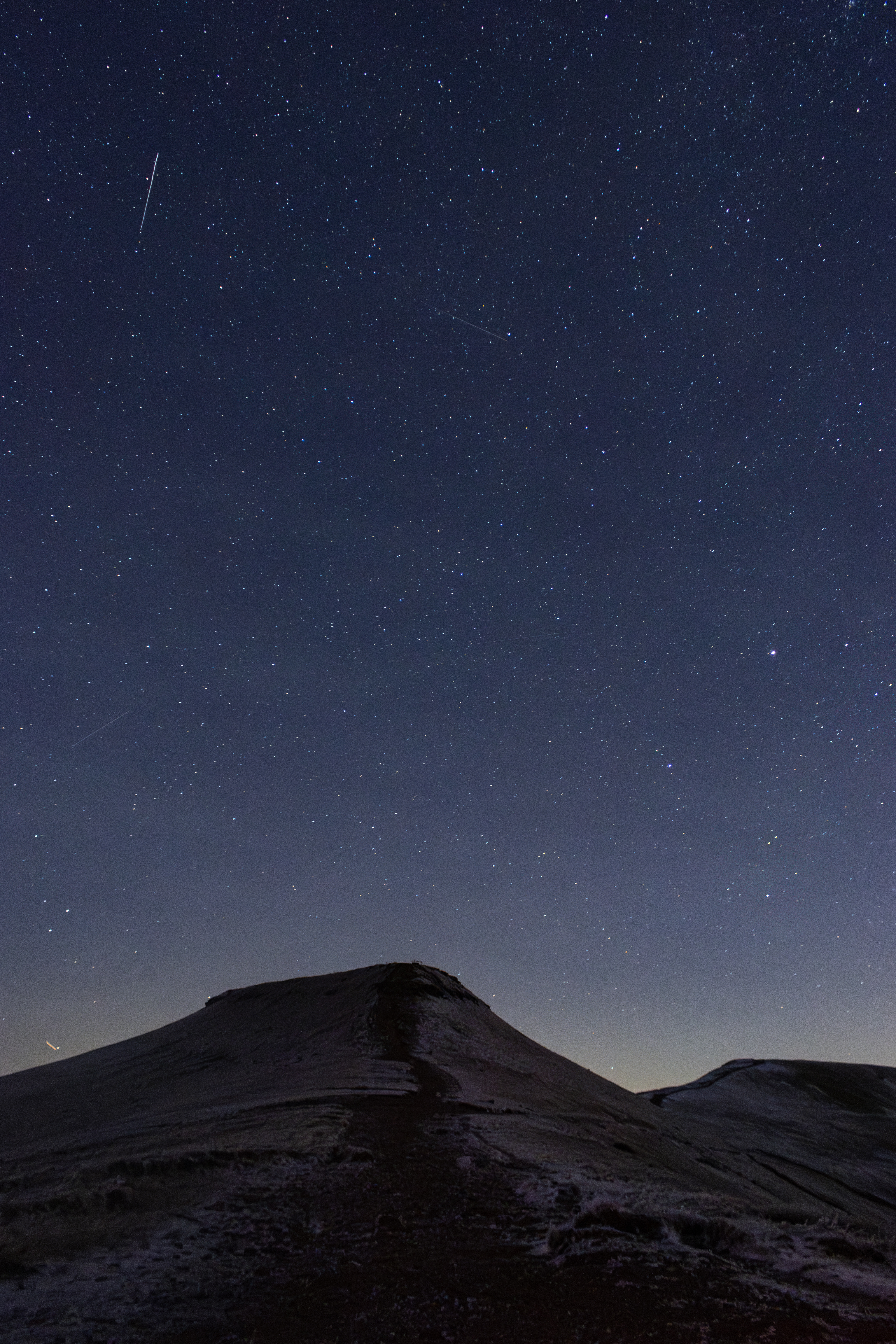 Stars above a mountain ridge at night